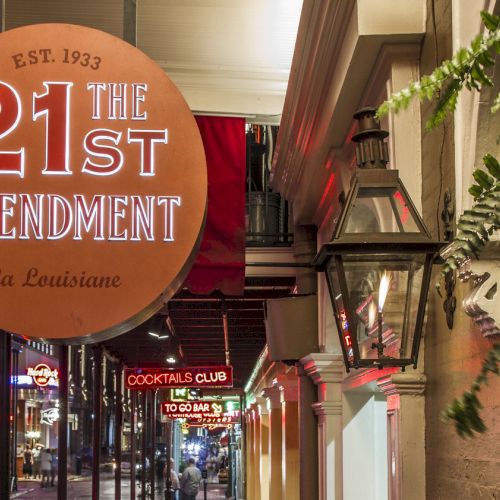 A street view with the "21st Amendment" sign and other signs in the background, offering a lively and inviting atmosphere.